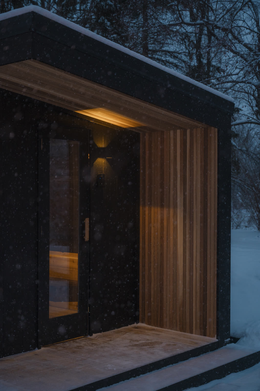 Close view of the cedar entry with the sconce lit