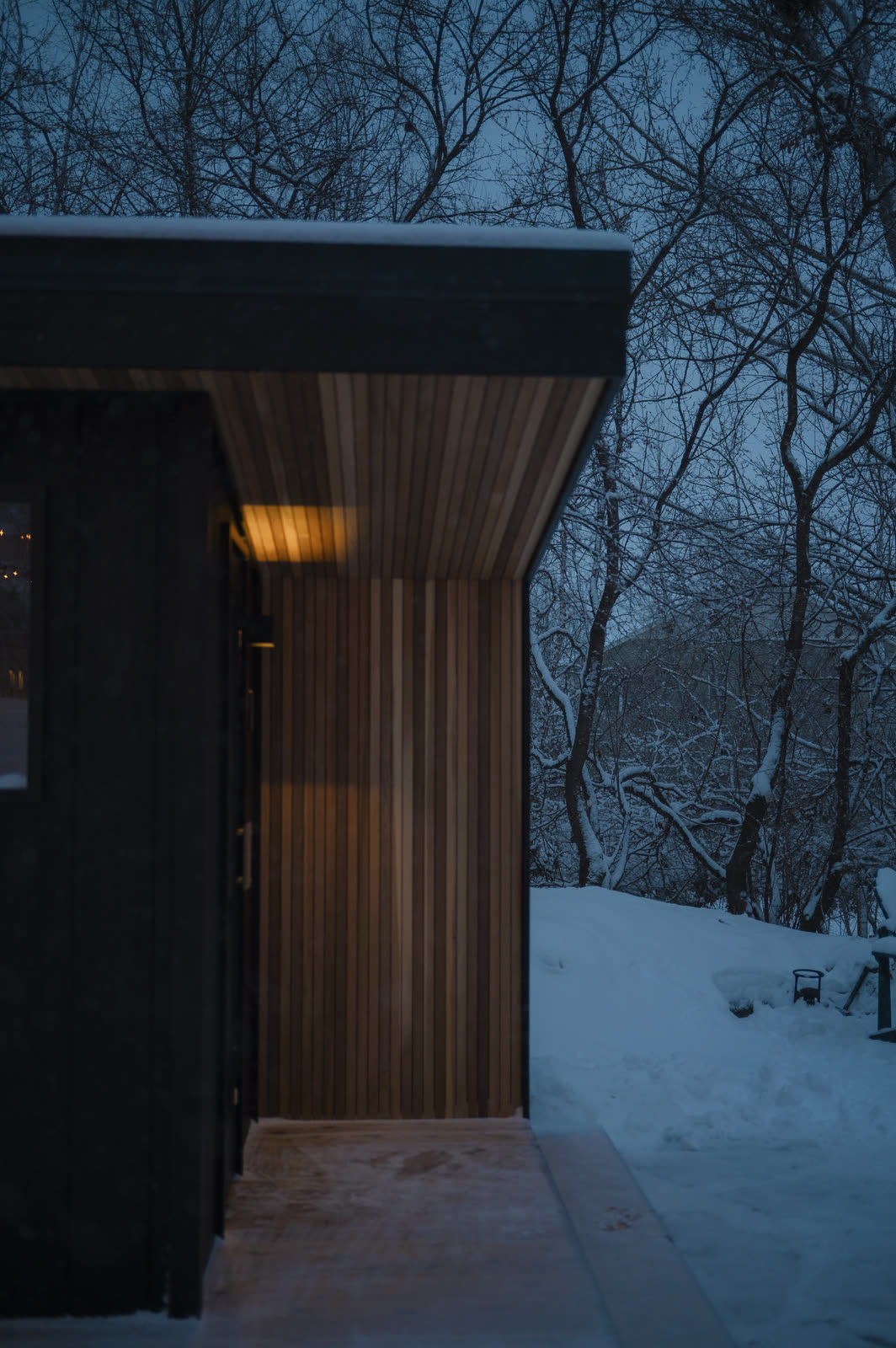 The cedar-wrapped entry from the front, door ajar