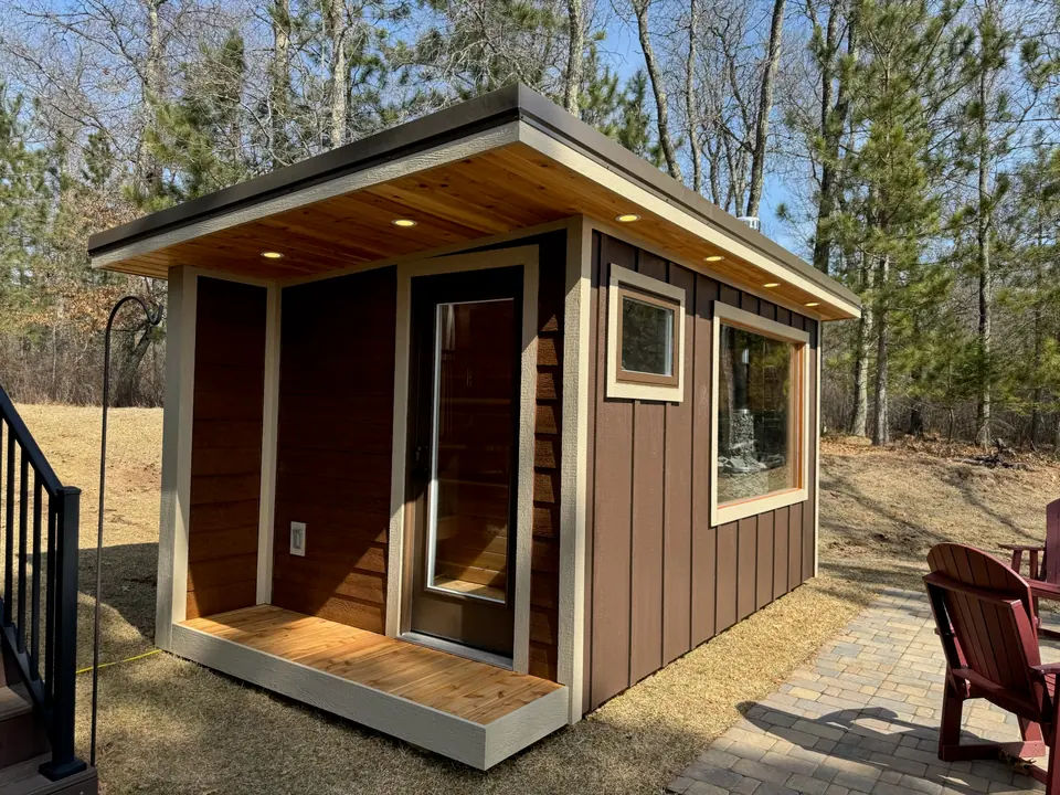 Superior sauna with a covered porch and a large front window