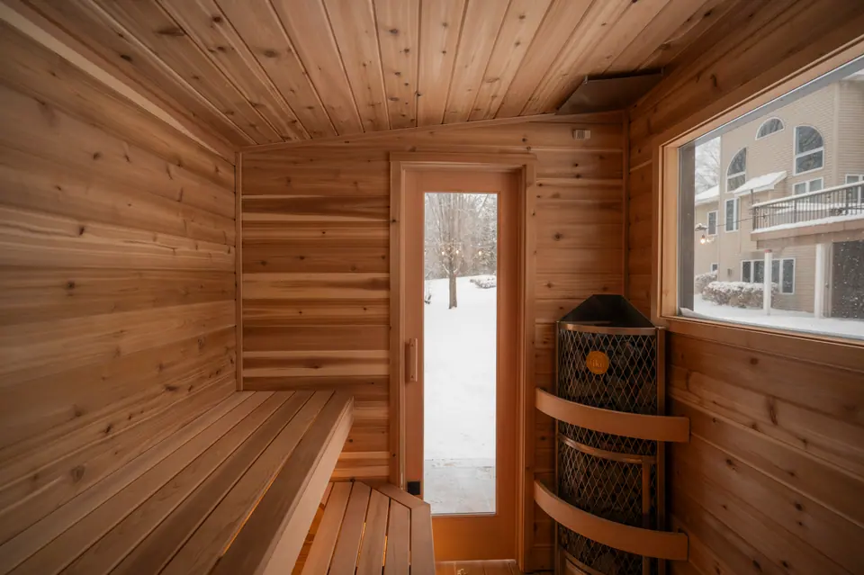 Tuli sauna interior looking toward the glass door and the stove