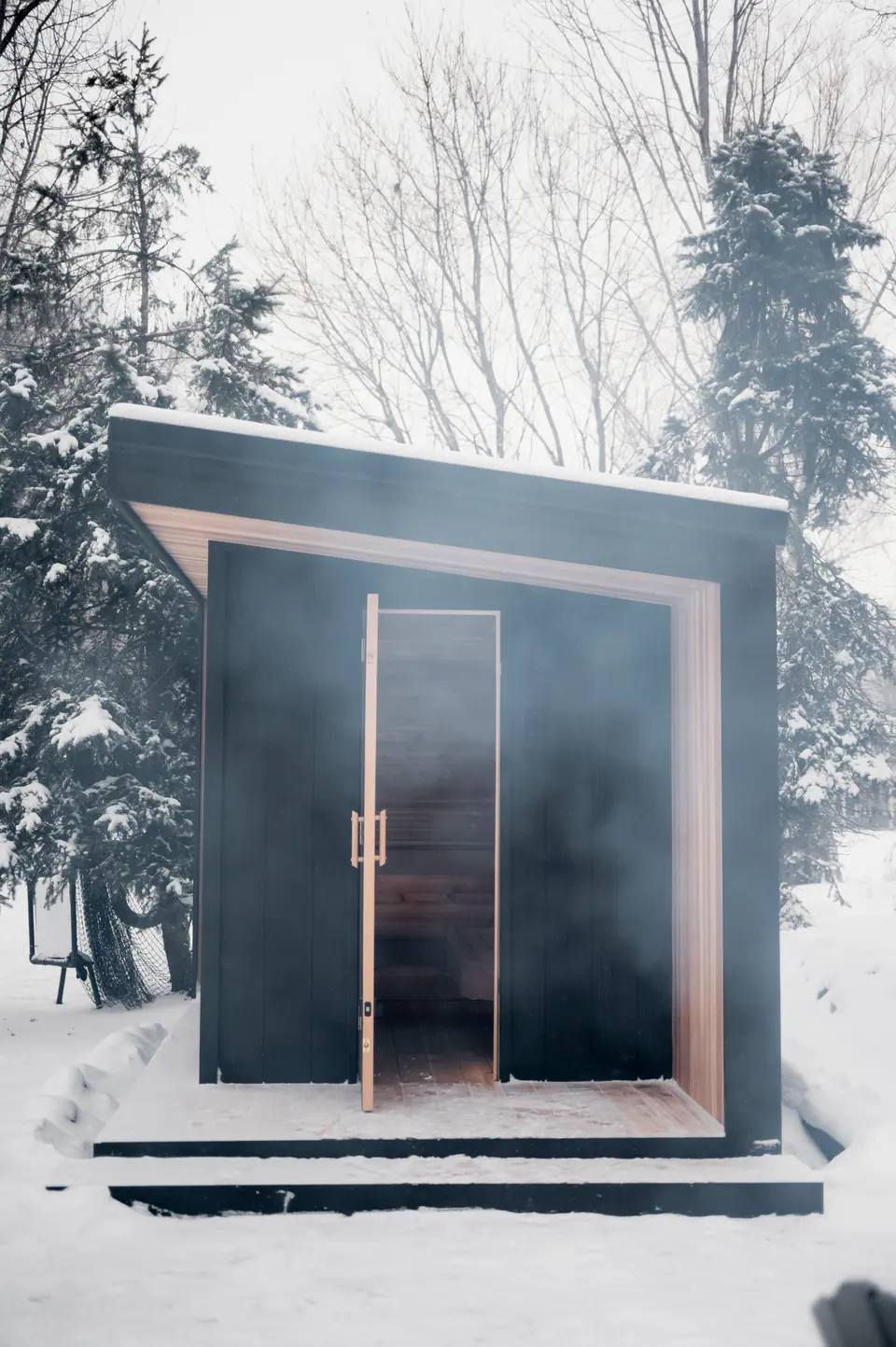 Tuli sauna with the glass door open on a winter day